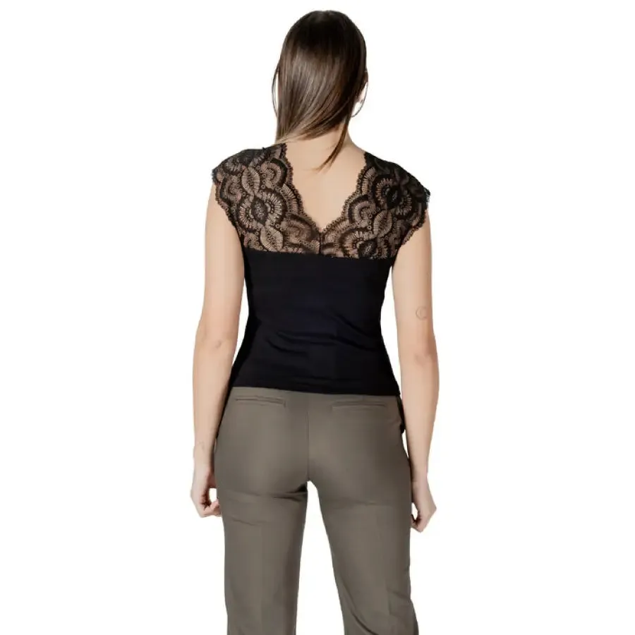 Woman in Black Lace Trimmed Top and Khaki Pants